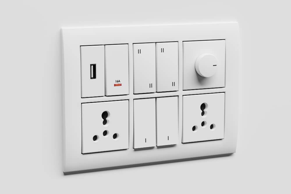 A modern electrical switchboard featuring multiple switches, universal power sockets, a USB port, and a fan regulator knob, manufactured by top fan regulator manufacturers in India.